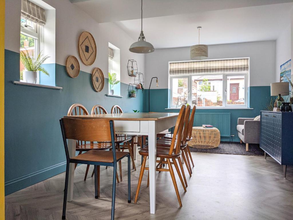a dining room with a table and chairs at Beautifully decorated large family home in seaside town with large garden in Colwyn Bay