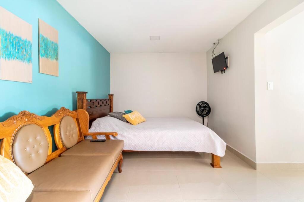 a room with two beds and a couch in it at Apartamento-San José-WiFi in San José