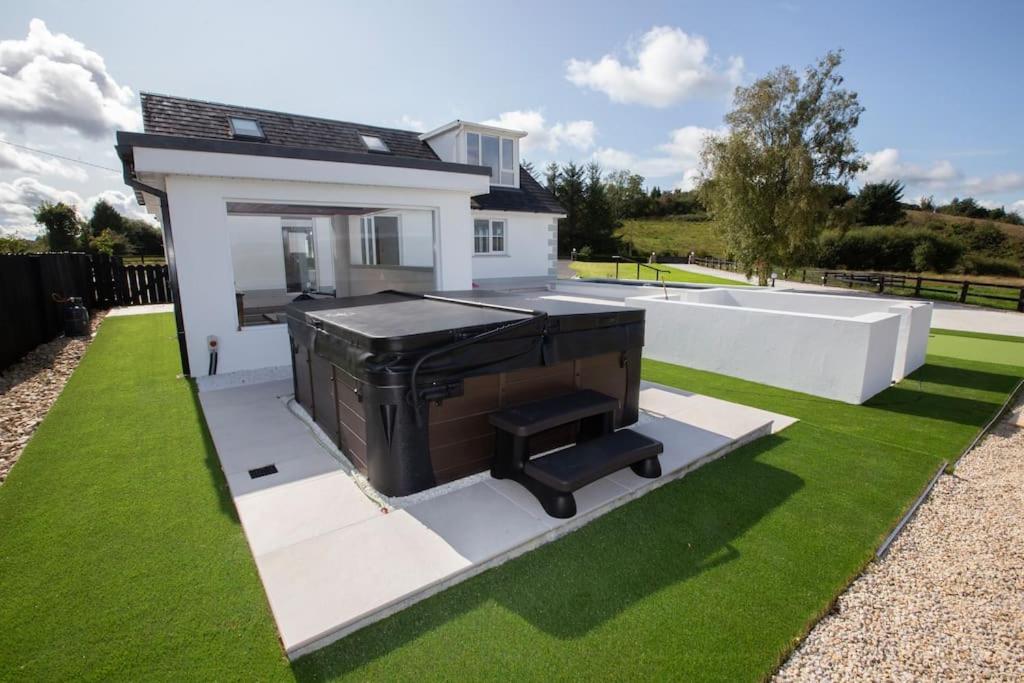 a rendering of a house with a piano on a lawn at Guest House with hot tub - Boyle in Boyle