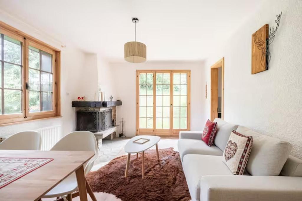 a living room with a couch and a table at Rare, quite & centered Apartment with Garden & Fireplace in Villars-sur-Ollon