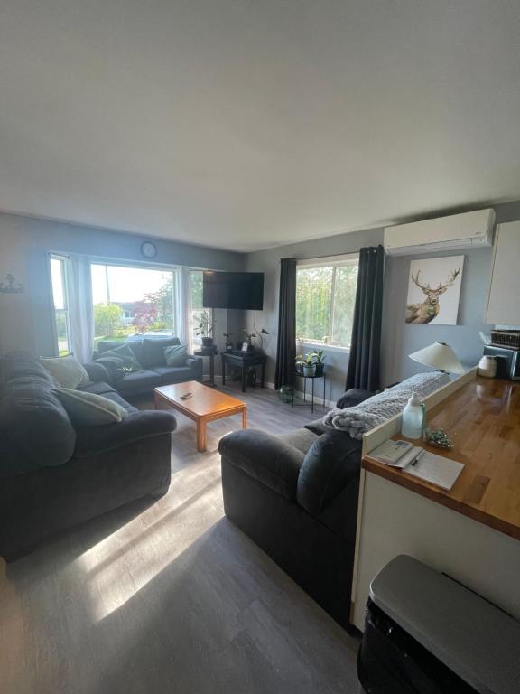 a living room with a couch and a table at Sunrise Mountain view Skidegate House in Skidegate
