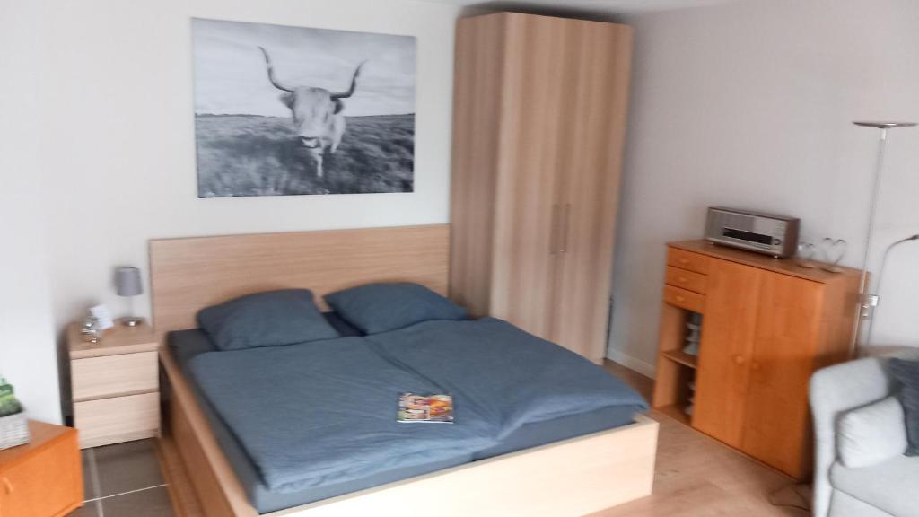a bedroom with a bed with a deer head on the wall at Ferienwohnung Evi's Herzallerliebst in Brilon