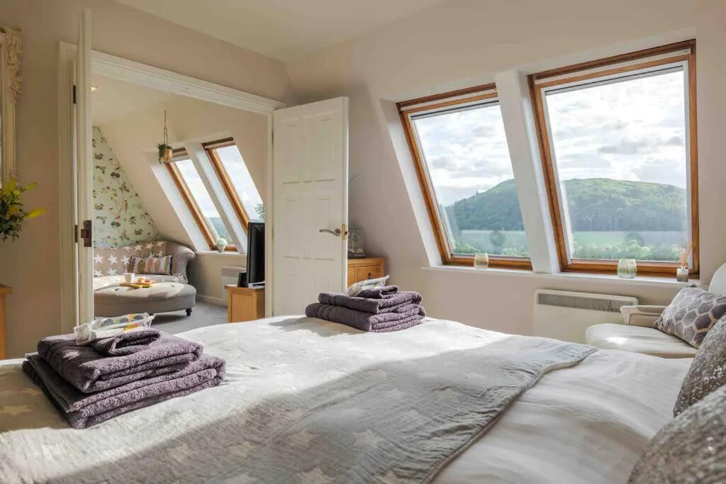 a bedroom with a large bed with towels on it at Serendipity ~ Romantic Hideaway in Ambleside in Ambleside
