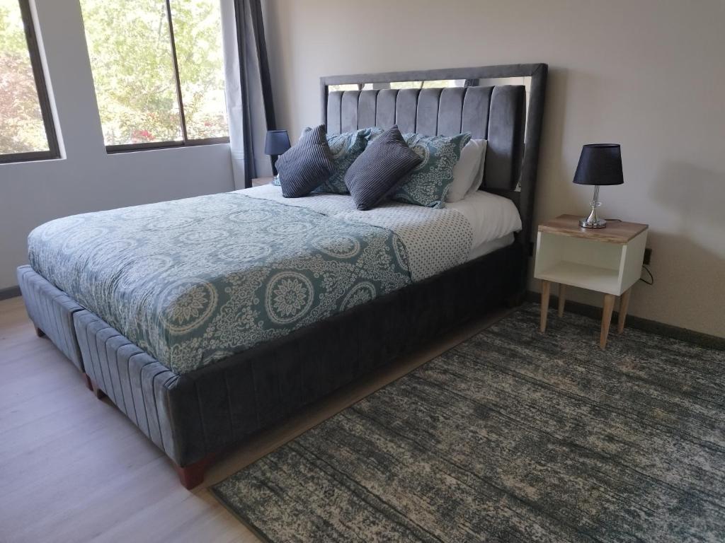 a bedroom with a large bed with a rug at Costanera Bed & Breakfast in Santiago