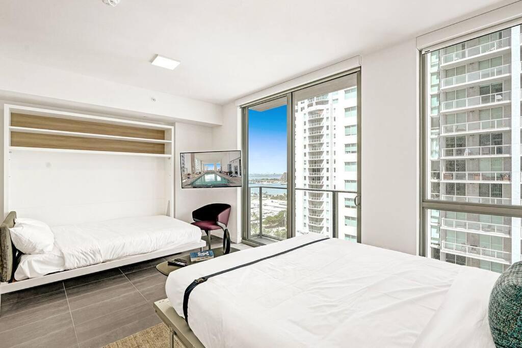 um quarto com uma cama e uma grande janela em Miami Studio Light View em Miami