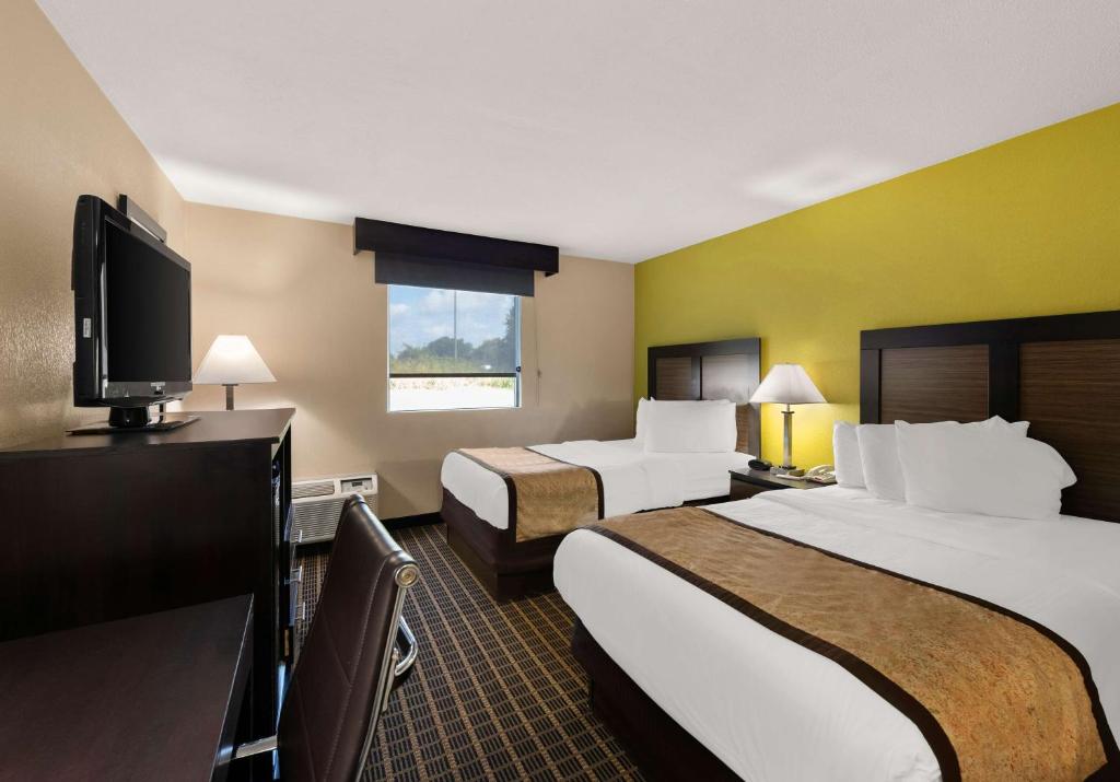 a hotel room with two beds and a flat screen tv at Best Western Adena Inn in Chillicothe
