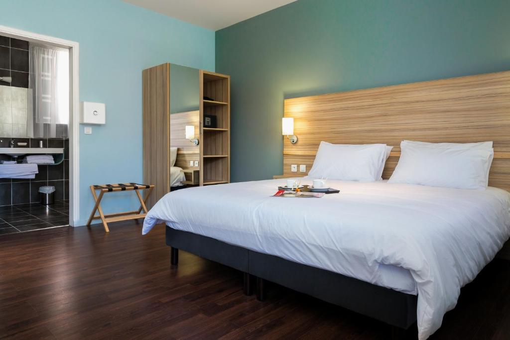 Postel nebo postele na pokoji v ubytování Eclipse Belle Etoile Appart'hôtel