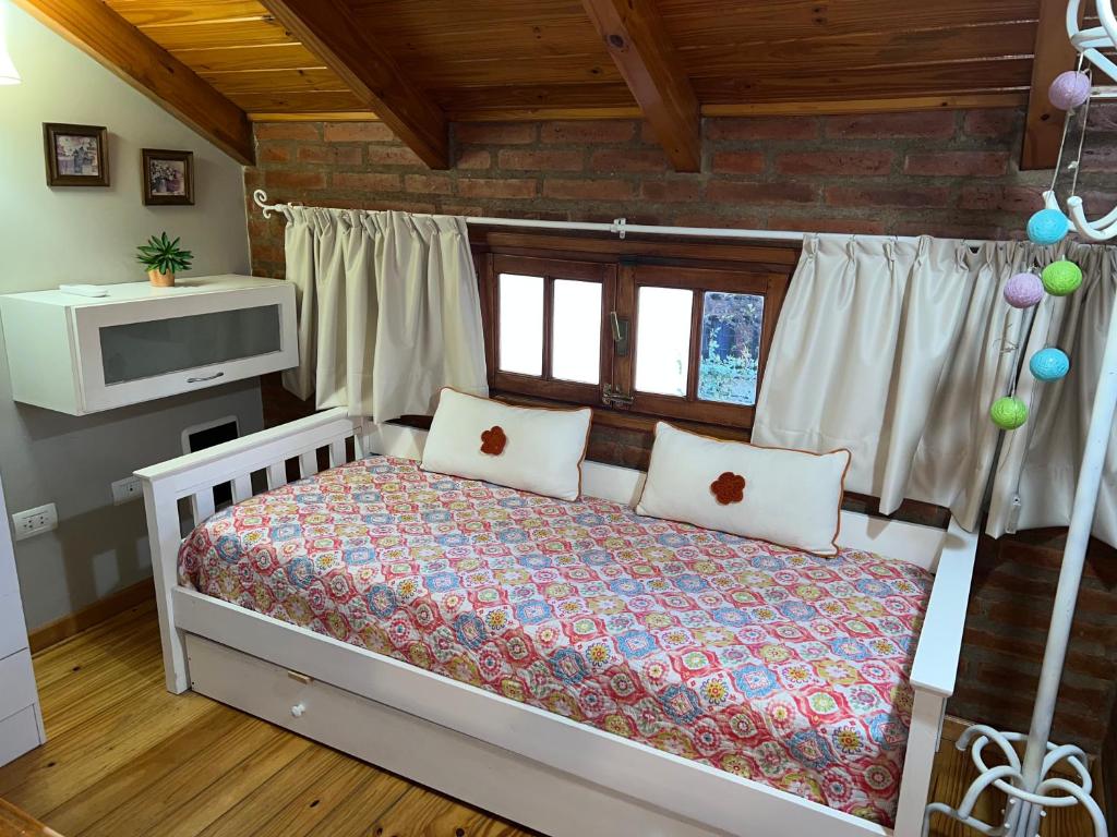 a bedroom with a bed with two pillows at Casamia Altos in Bahía Blanca