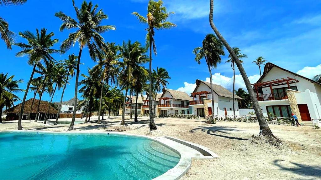 a swimming pool in front of a house with palm trees at Ocean View Villa with pool, Zanzibar in Pingwe