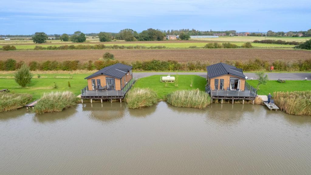 an aerial view of two houses on an island in the water at Lakeside Fishing Cabins in Boston