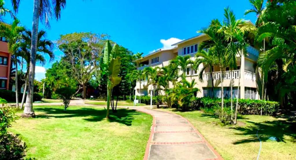 un complejo con palmeras y una pasarela en Paradis Mimies Apartment, en Boca Chica