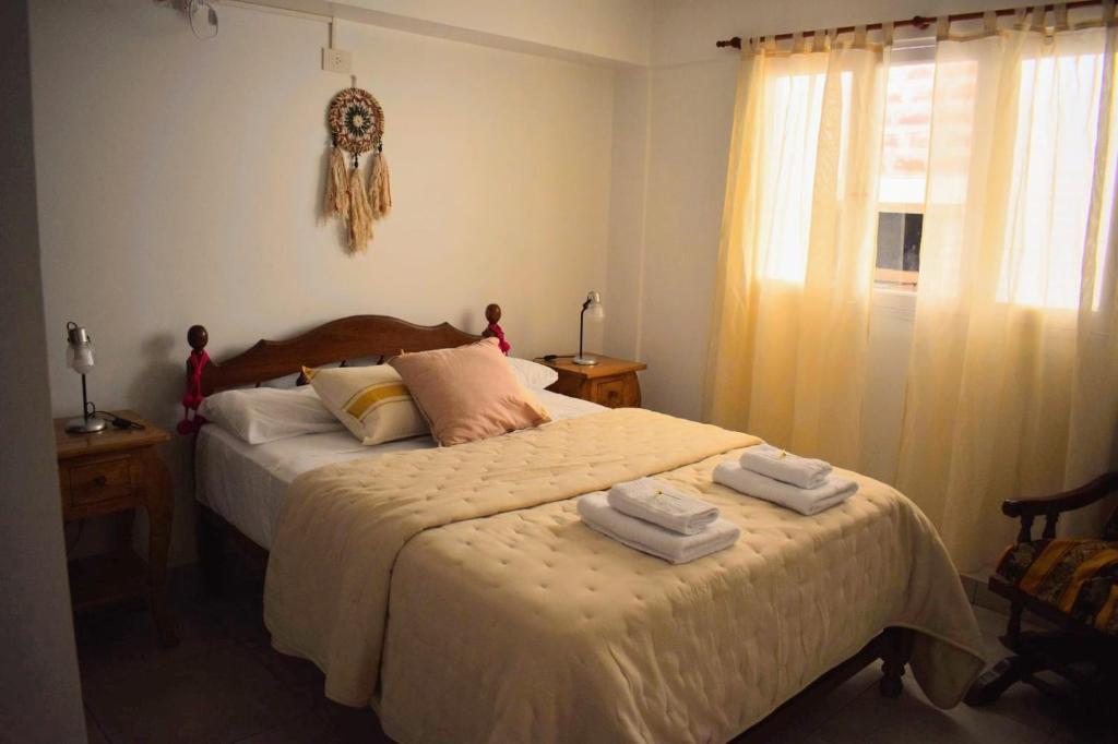 a bedroom with two beds with towels on them at Ukiyo Apart in San Salvador de Jujuy