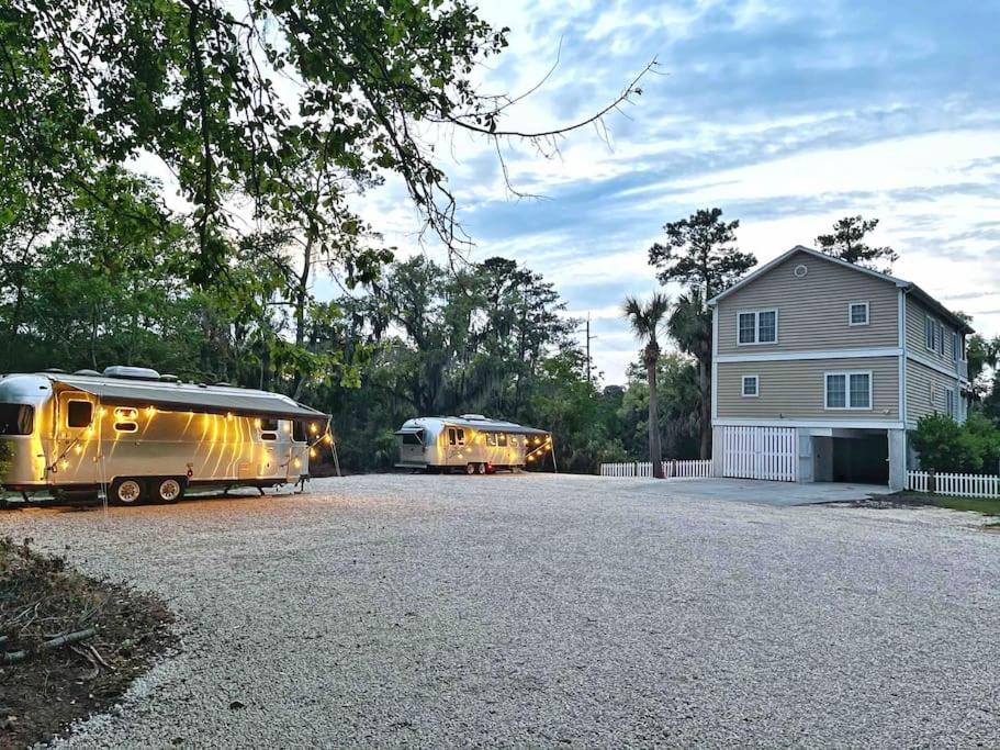 two rvs parked in a parking lot next to a house at Large 4bed/4bath Home + 2 Airstream Glampers & Spa Midway to Tybee Beach & Downtown Savannah with Fast WiFi and More! in Savannah