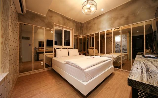 a large bedroom with a large white bed in it at B-Bas Hotel in Daegu