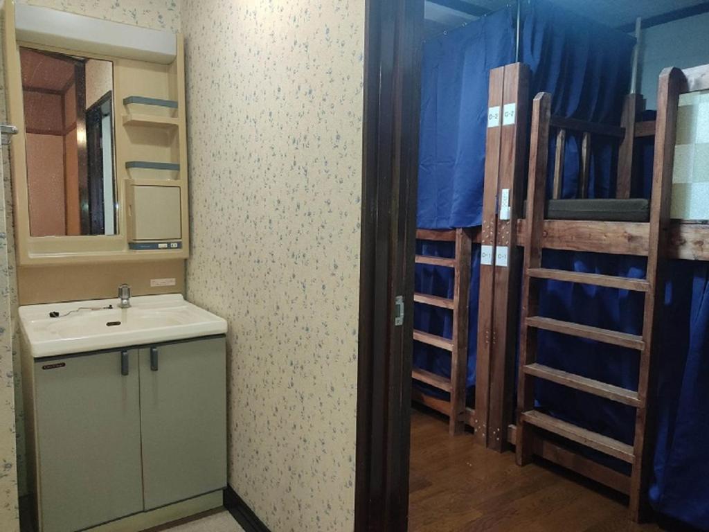 Postel nebo postele na pokoji v ubytování Guesthouse Kincha 駅東口
