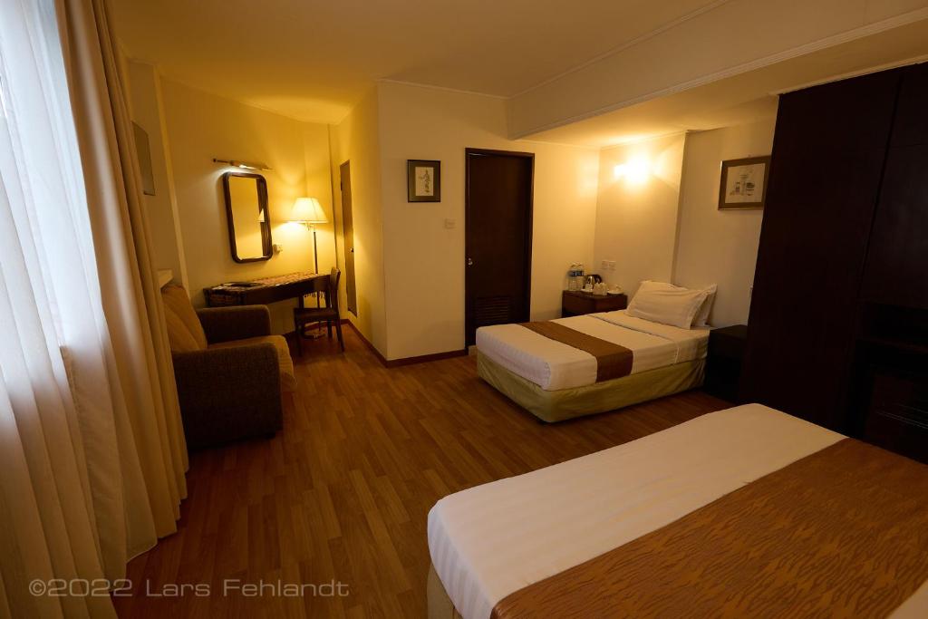 Postel nebo postele na pokoji v ubytování Telang Usan Hotel Kuching