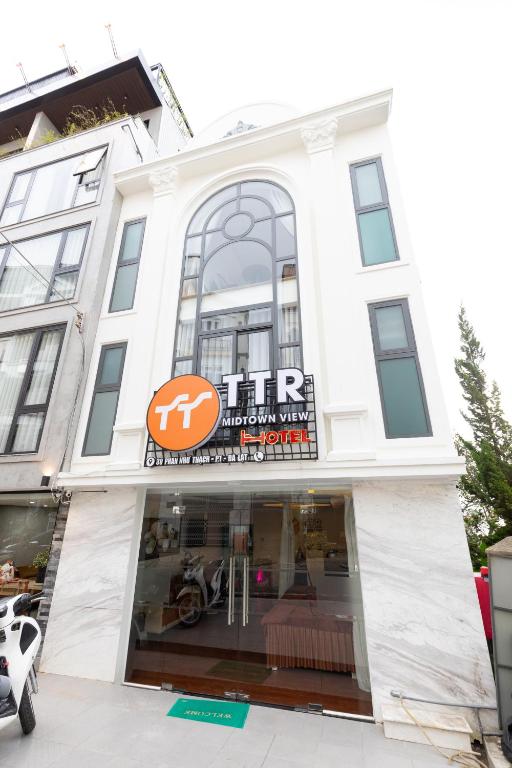 a store front of a white building at TTR Midtown View Hotel in Da Lat