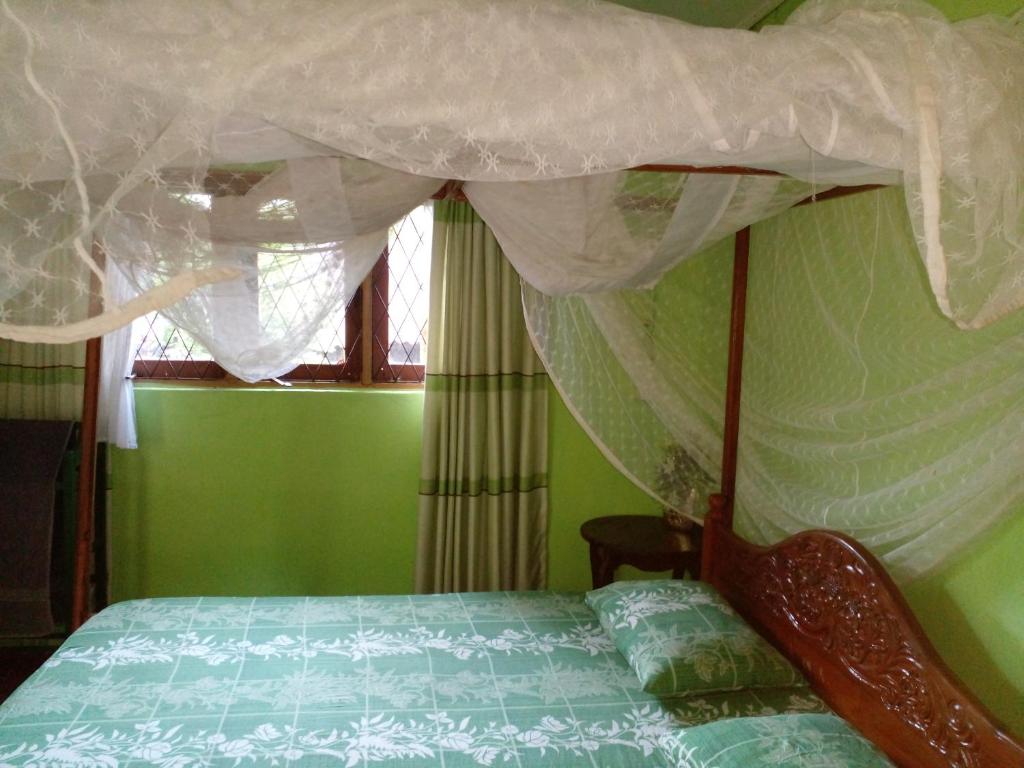 Postel nebo postele na pokoji v ubytování Pradeepa house