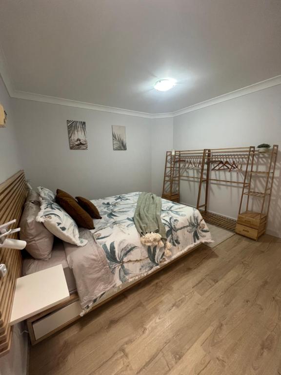 a bedroom with a bed and two bunk beds at Sussex Gem - Cozy apartment in the heart of Sussex in Sussex Inlet