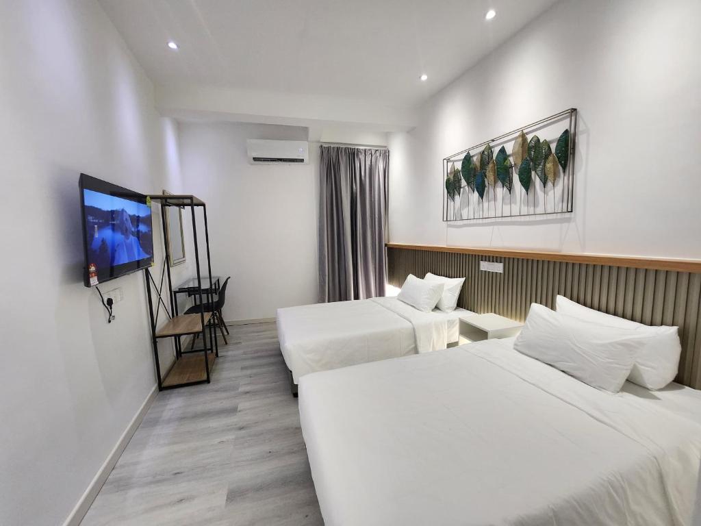 Postel nebo postele na pokoji v ubytování One Point Hotel