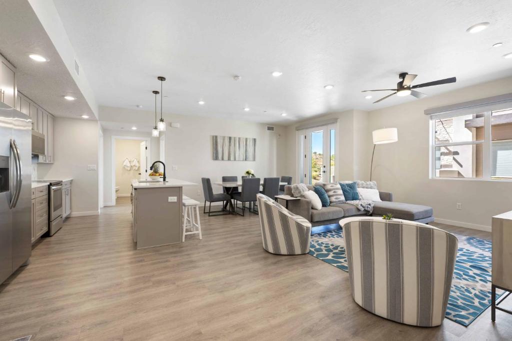 a living room and kitchen with a couch and a table at Primo Lagoon Retreat condo in St. George