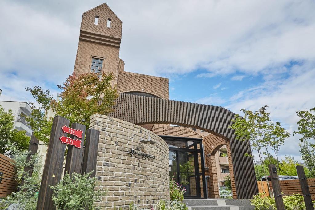 a brick building with a clock tower on top of it at Riverside Arashiyama in Kyoto