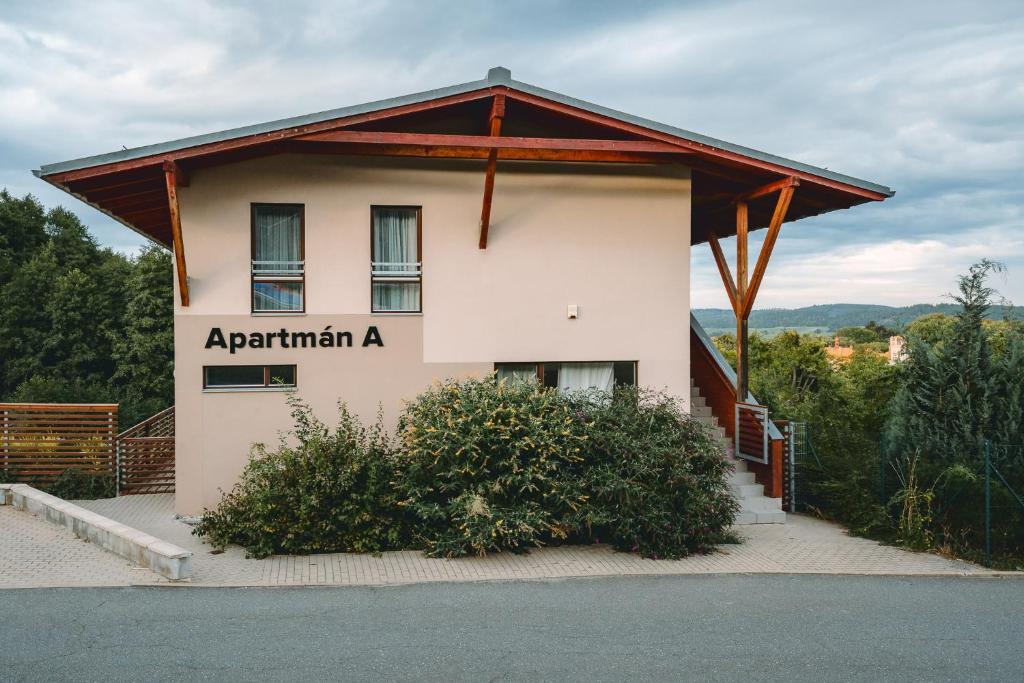 a building with a sign on the side of it at Apartmán A5 pro 3 osoby - Monínec - celoročně in Moninec