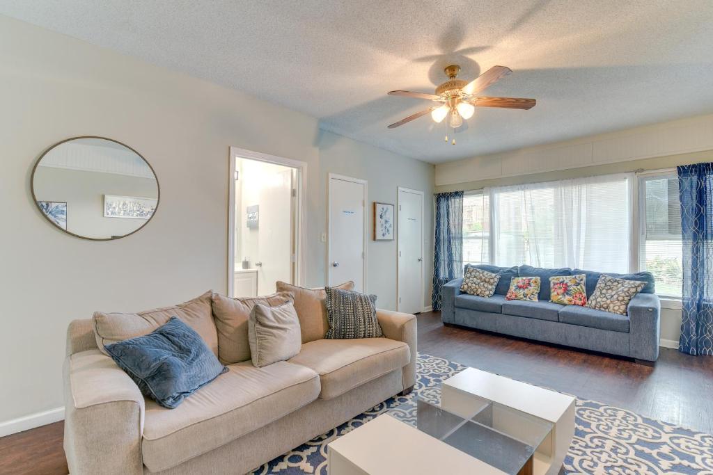 a living room with a couch and a ceiling fan at Galveston Vacation Rental - Walk to the Beach! in Galveston