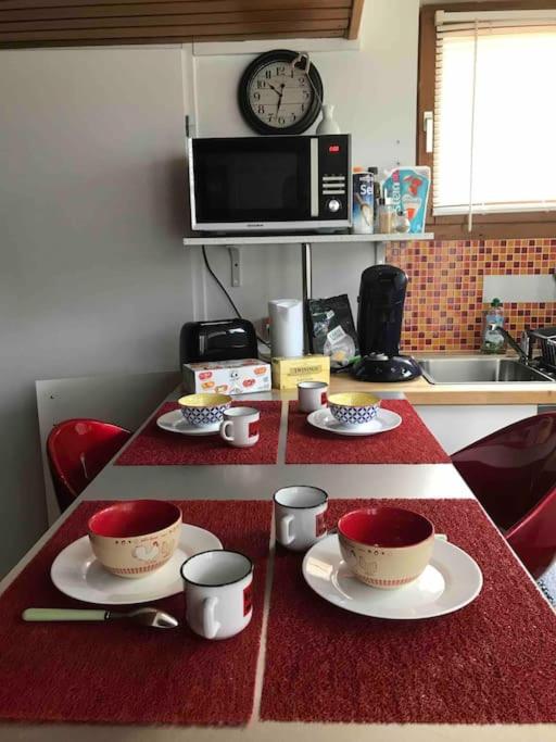 - un comptoir de cuisine avec deux tasses et des soucoupes dans l'établissement Studio 1 à 4 pers, proche Strasbourg, Europa-Park, Colmar, à Erstein
