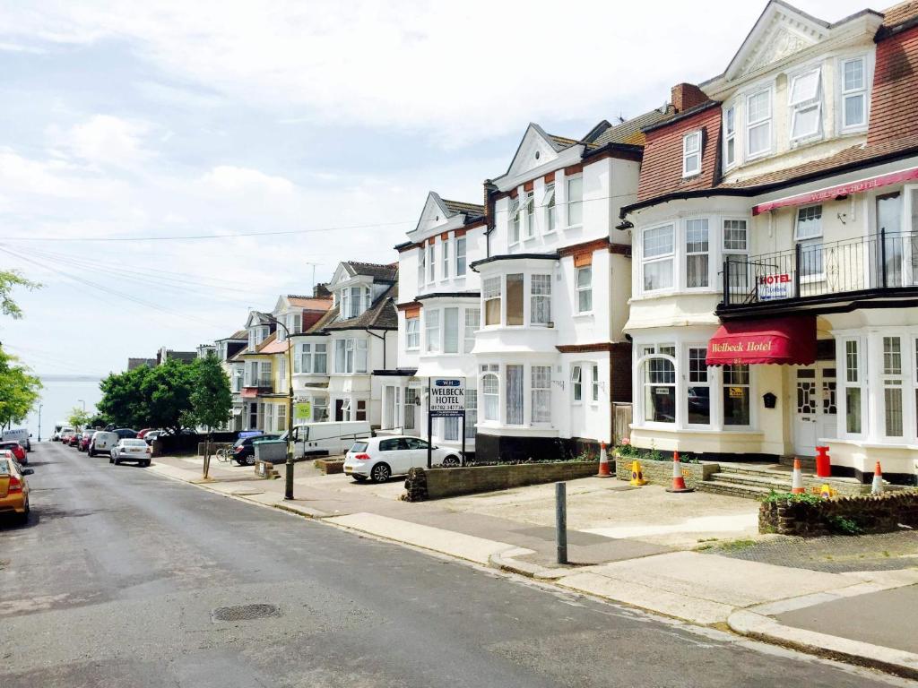 a row of houses on a street with parked cars at Welbeck Hotel - Close to Beach, Train Station & Southend Airport in Southend-on-Sea