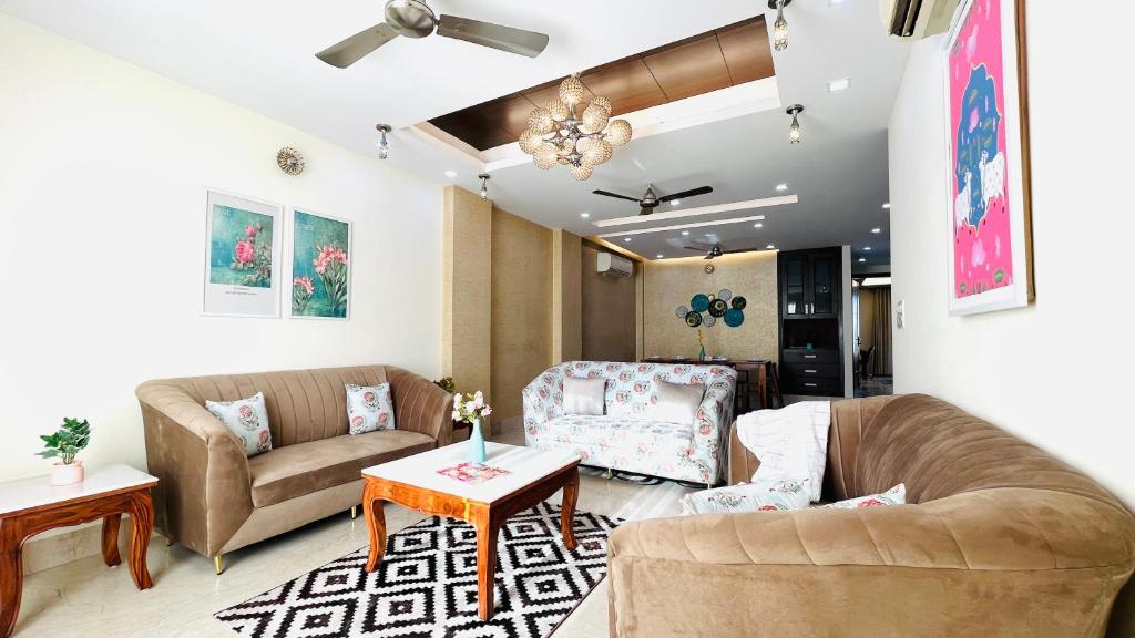 a living room with two couches and a table at Olive Serviced Apartments - Defence Colony in New Delhi