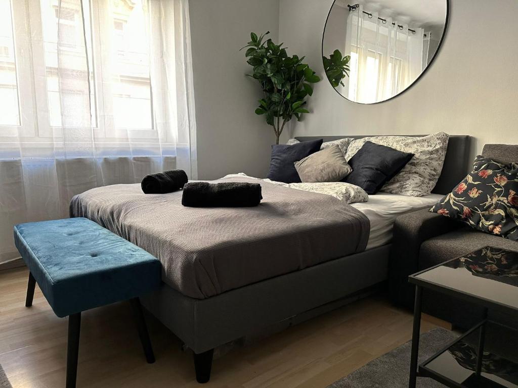 a living room with a bed and a couch at Balcony Apartment, 1 min to U1 Reumannplatz in Vienna
