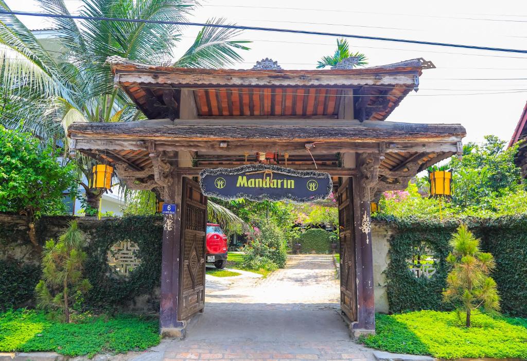 an entrance to a garden with a sign that reads miami at Mandarin Homestay Hue in Hue