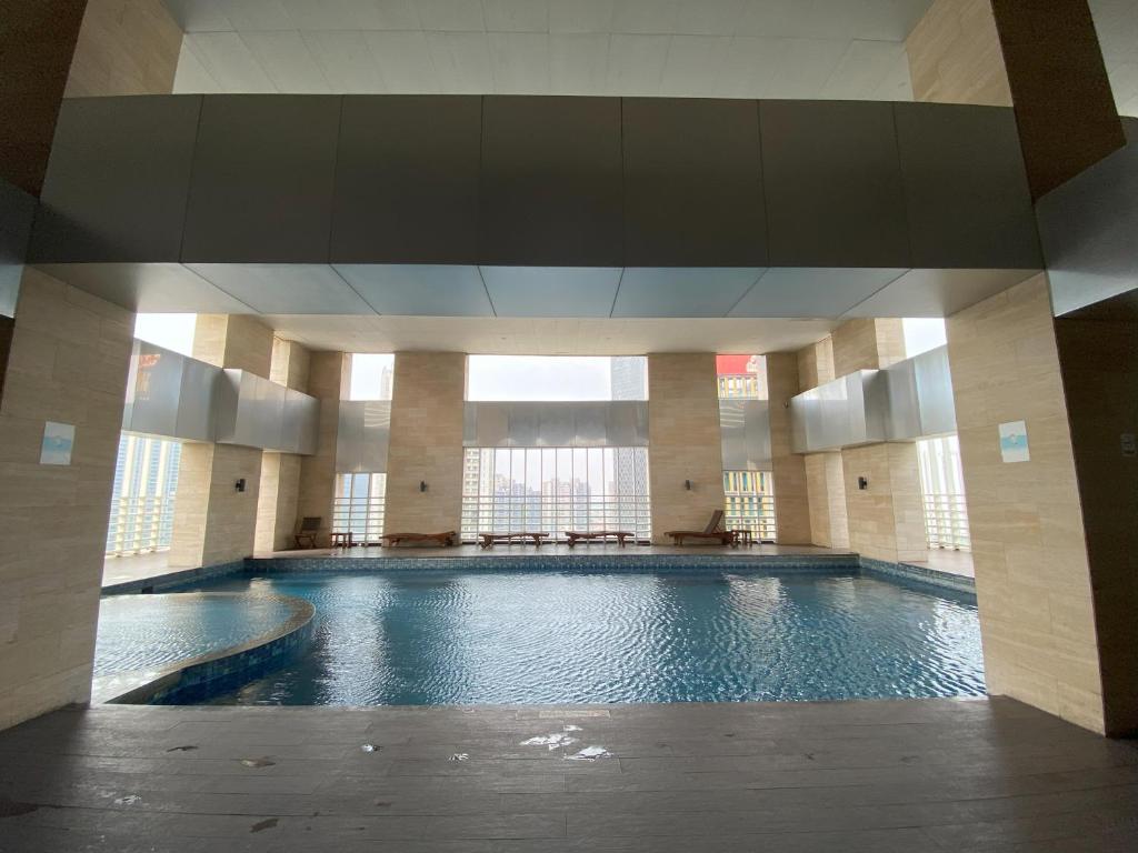 a large swimming pool in a large building at 1 Bedroom Executive Suite apartment at The H Tower Kuningan Jakarta by Lorenso in Jakarta