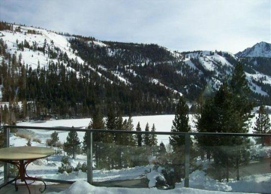 a balcony with a table and a snow covered mountain at Rr-carson_view1 Strap18-005 in June Lake