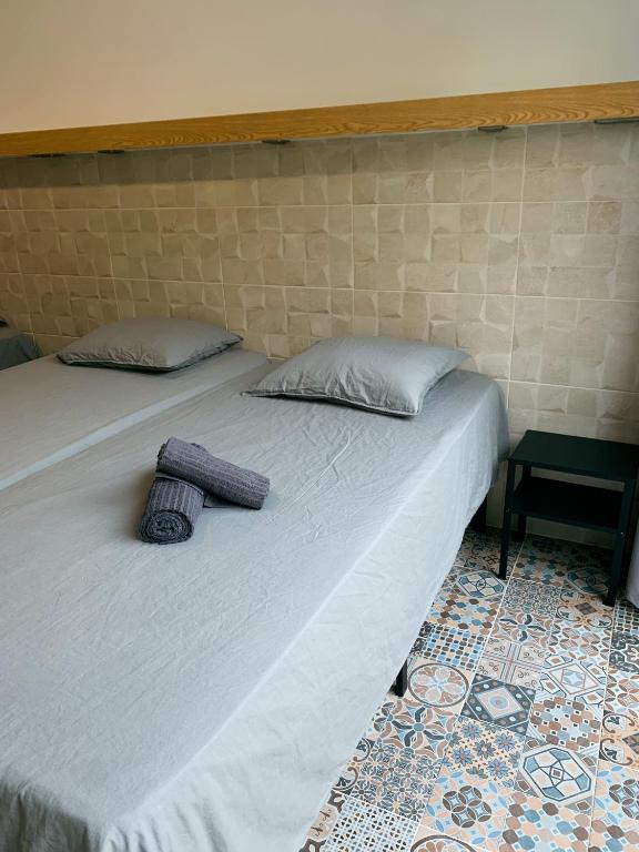 a bed with two pillows on it in a room at Apartamentos La Ruta in Calpe