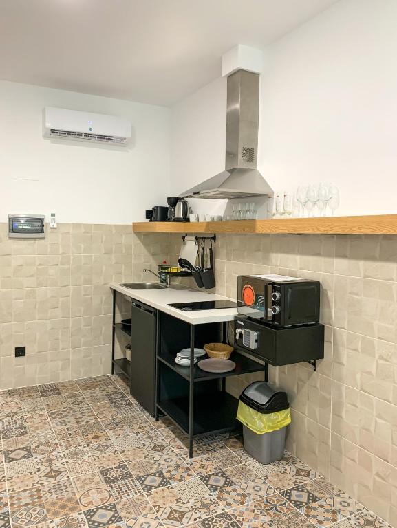 a kitchen with a counter and a stove in it at Apartamentos La Ruta in Calpe