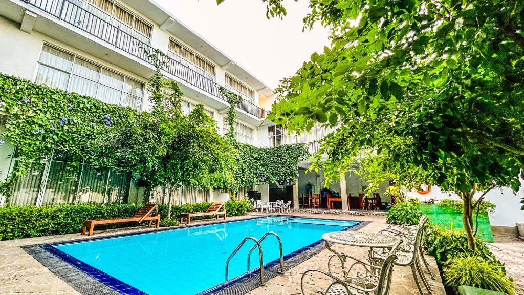 a swimming pool in front of a building at Salubrious Resort in Anuradhapura