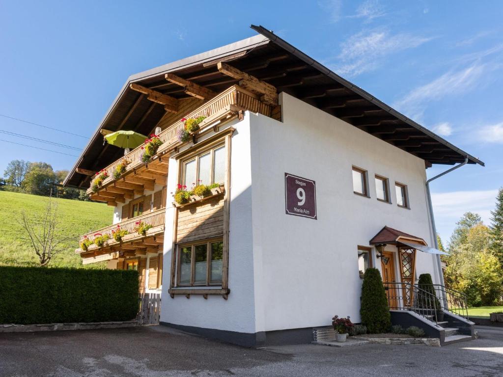 a white building with a sign on it at Scenic Apartment in Maria Alm near Ski Lift in Maria Alm am Steinernen Meer