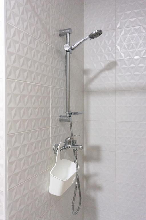 a shower with a shower head in a bathroom at Apartamentos La Ruta in Calpe