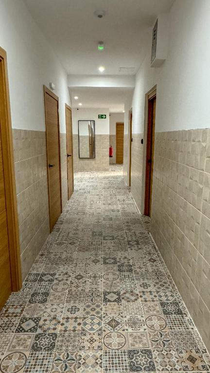 an empty hallway with a tile floor in a building at Apartamentos La Ruta in Calpe