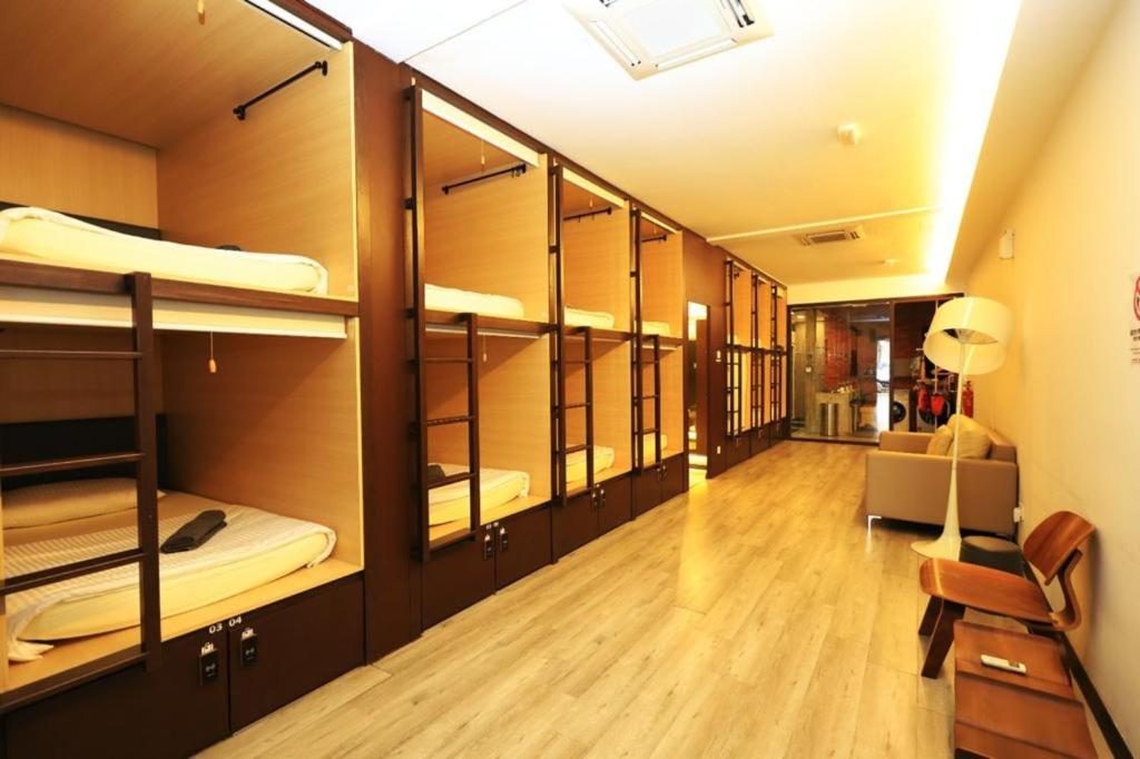 a room with several bunk beds with a hallway at Sogor Female Dormitory in George Town