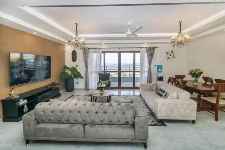 a living room with two couches and a television at Turkana Flat apartment in Nakuru