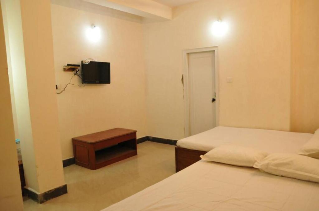 Postel nebo postele na pokoji v ubytování MYSORE MAHALAKSHMI ROOMS