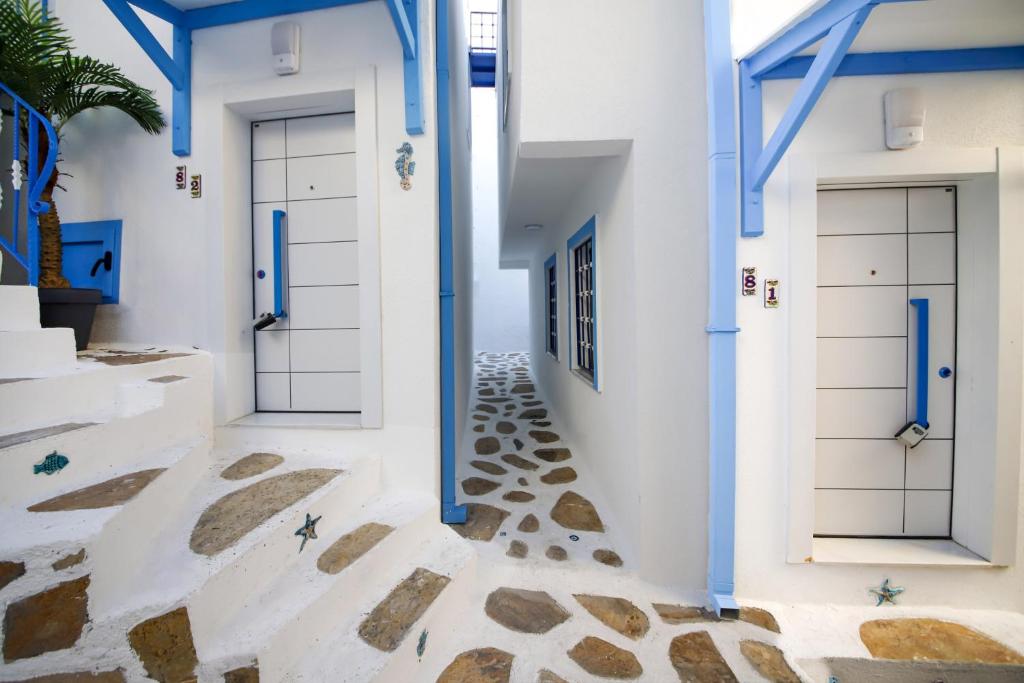 a hallway with blue doors and rocks on the floor at Cozy Seaside Paradise 3 min to Beaches in Bodrum in Bodrum City