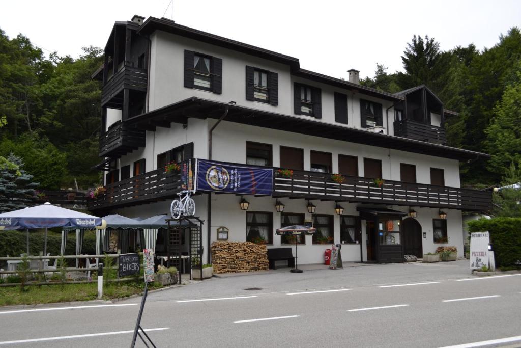 a large white building on the side of a street at Appartamenti Vacanze Lagolo in Lagolo di Calavino