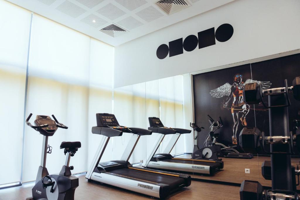 a gym with treadmills and exercise bikes in a room at ONOMO Airport Casablanca in Casablanca