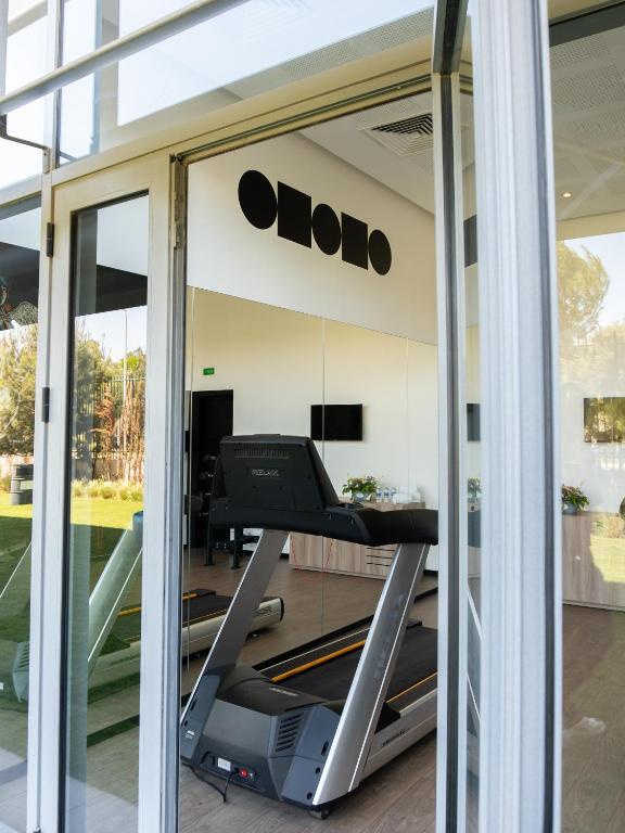 a gym with a treadmill in front of a window at ONOMO Airport Casablanca in Casablanca