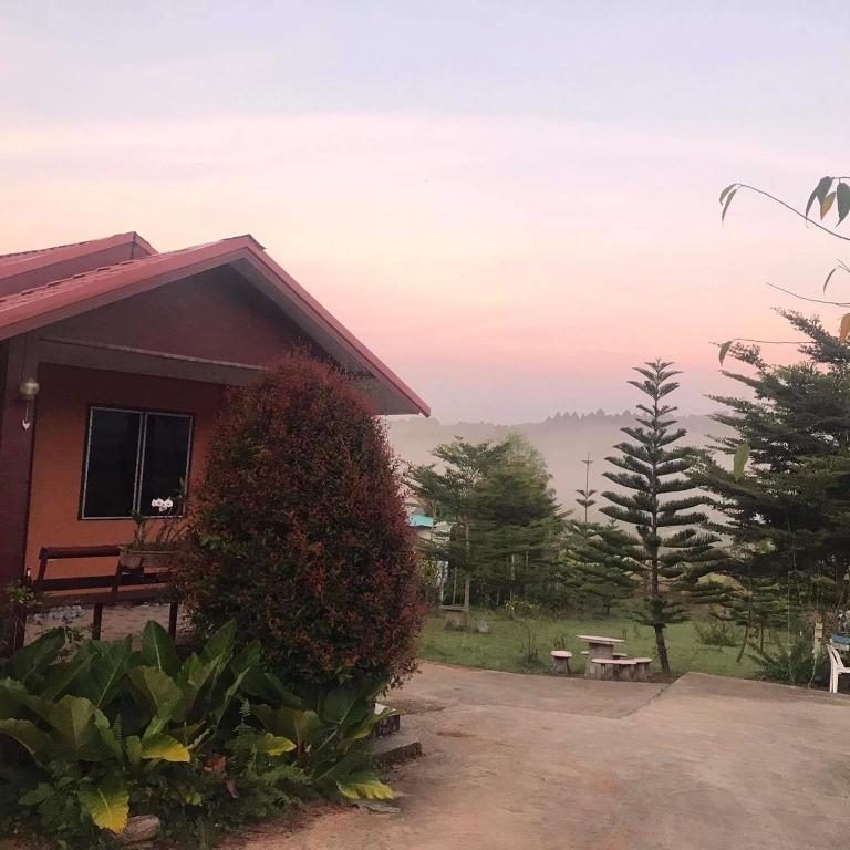 a house with a table and a bench in front of it at Tonkaew Khaokao Resort in Campson