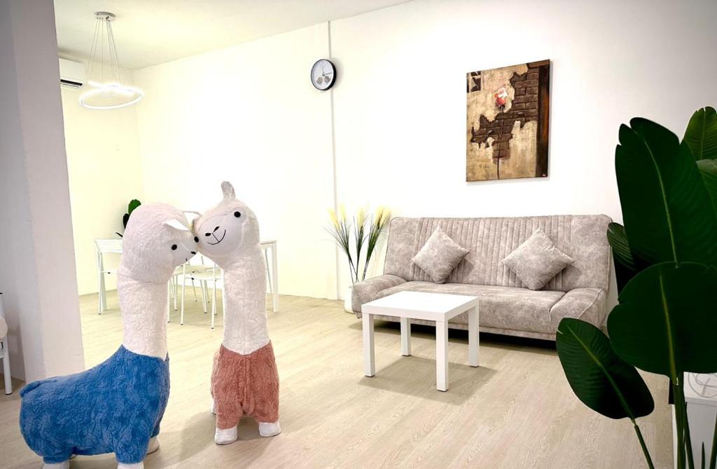 two stuffed animals in a living room with a couch at ALVILLA - Jalan Sultan Ismail in Kuala Terengganu